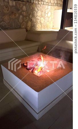 Evening Lounge, Fire Feature With Plush Furnishings, Chic Indoor Space With Fiery Centerpiece And Comfortable Seating, Stylish Contemporary Lounge Adorned With Warm Lighting And Glowing Fire Table Evening Lounge, Fire Feature With Plush Furnishings, Chic Indoor Space With Fiery Centerpiece And Comfortable Seating, Stylish Contemporary Lounge Adorned With Warm Lighting And Glowing Fire Table 134810339