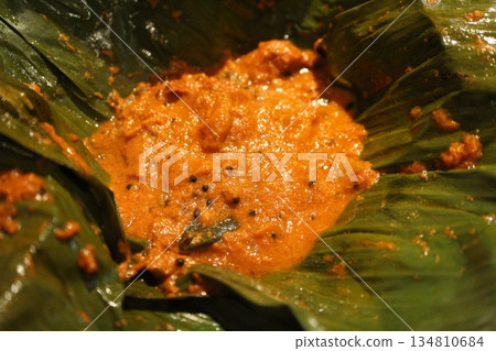 Indian cuisine: Shrimp curry wrapped in banana leaves Indian cuisine: Shrimp curry wrapped in banana leaves 134810684