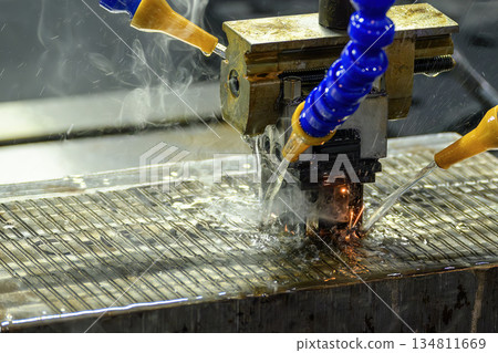 The mold production process by EDM machine working with graphite electrode. The mold production process by EDM machine working with graphite electrode. 134811669