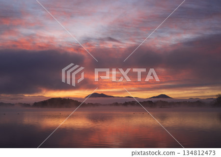 Dawn sky and clouds reflected on the lake surface 134812473