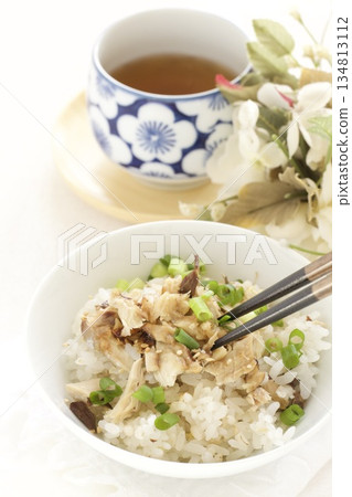 Grilled mackerel topped with rice and Japanese tea Grilled mackerel topped with rice and Japanese tea 134813112