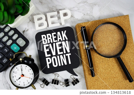 BEP - Break Even Point acronym with calculator, alarm clock and magnifying glass, Business concept background 134813618