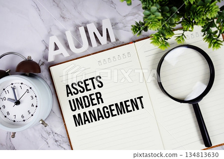 AUM - Assets Under Management acronym on notepad, Business concept background AUM - Assets Under Management acronym on notepad, Business concept background 134813630
