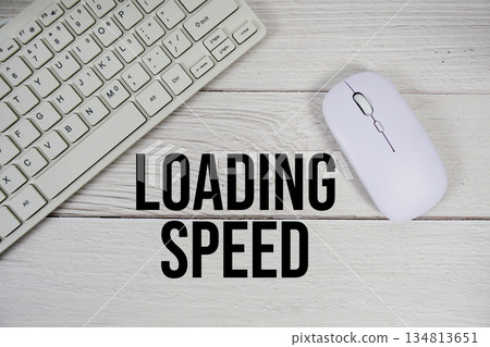 Loading Speed text with keyboard and wireless mouse on wooden background Loading Speed text with keyboard and wireless mouse on wooden background 134813651