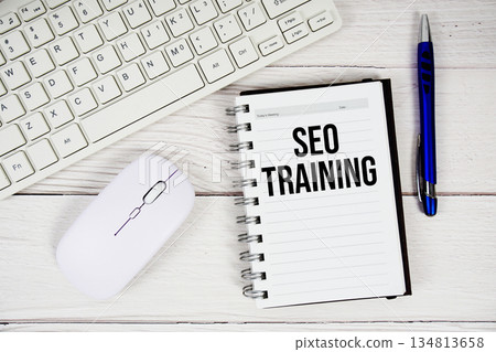 SEO Training text with keyboard and wireless mouse on wooden background 134813658