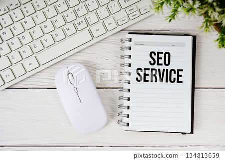 SEO Service text with keyboard and wireless mouse on wooden background SEO Service text with keyboard and wireless mouse on wooden background 134813659