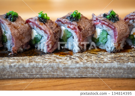 Wagyu Sushi roll with cream cheese, served on plate 134814395
