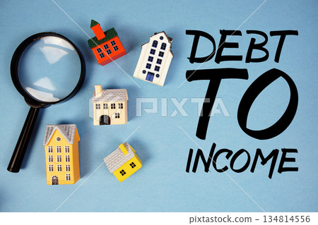 DTI Debt To Income Ratio text with house models and magnifying glass on blue background 134814556