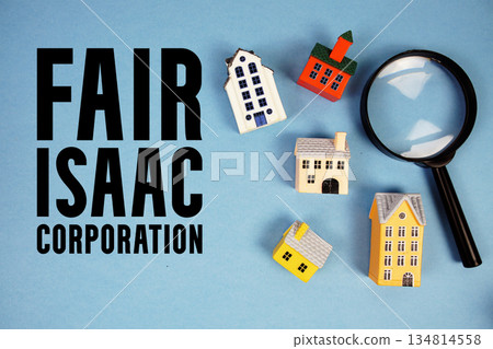 FICO Fair Isaac Corporation text with house models and magnifying glass on blue background FICO Fair Isaac Corporation text with house models and magnifying glass on blue background 134814558