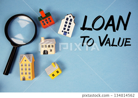 LTV Loan To Value text with house models and magnifying glass on blue background LTV Loan To Value text with house models and magnifying glass on blue background 134814562