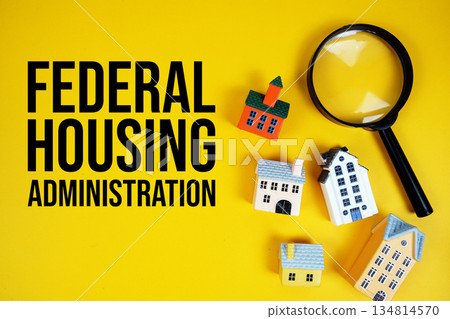FHA Federal Housing Administration text with house models and magnifying glass on yellow background FHA Federal Housing Administration text with house models and magnifying glass on yellow background 134814570