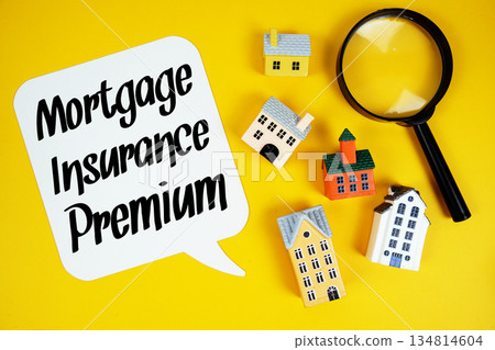 MIP Mortgage Insurance Premium text with house models and magnifying glass on yellow background 134814604