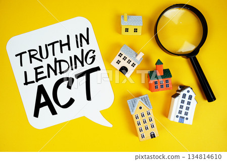 TIL Truth in Lending text with house models and magnifying glass on yellow background 134814610