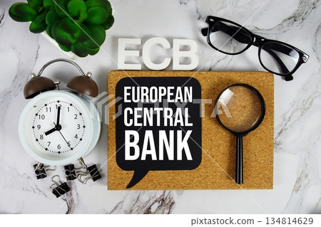 ECB - European Central Bank acronym with alarm clock and magnifying glass, financial concept background ECB - European Central Bank acronym with alarm clock and magnifying glass, financial concept background 134814629