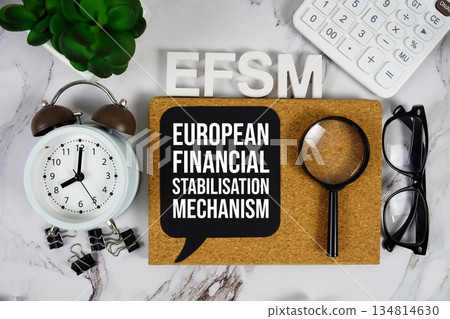 EFSM - European Financial Stabilisation Mechanism acronym with calculator, alarm clock and magnifying glass, Business and Financial concept background 134814630