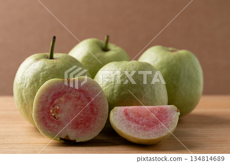 Sliced guava on wooden background, Tropical fruit high vitamin C Sliced guava on wooden background, Tropical fruit high vitamin C 134814689