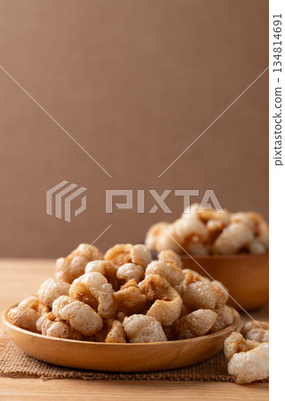 Pork rind on a wooden plate, Northern Thai food Pork rind on a wooden plate, Northern Thai food 134814691