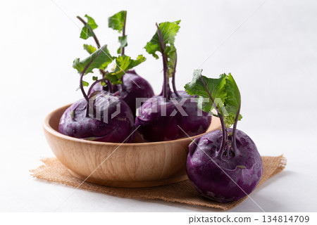 Purple kohlrabi or turnip cabbage in wooden bowl on white background Purple kohlrabi or turnip cabbage in wooden bowl on white background 134814709