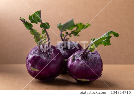 Purple kohlrabi or turnip cabbage on brown background Purple kohlrabi or turnip cabbage on brown background 134814710