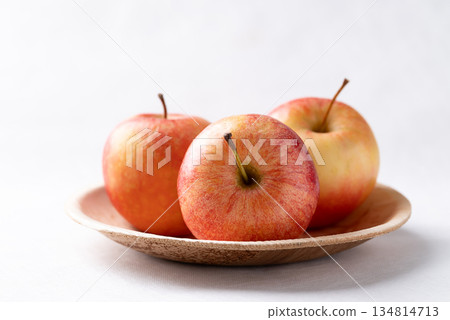 Red apple fruit (Gala apple) in natural plate on white background 134814713