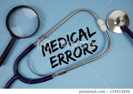 Medical Errors text with Stethoscope and magnifying glass on blue background 134814899