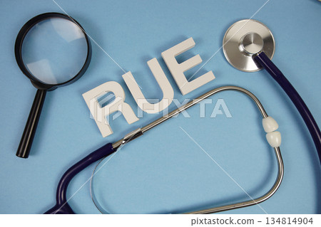 RUE abbreviation of Right Upper Extremity alphabet letters with magnifying glass and stethoscope on blue background RUE abbreviation of Right Upper Extremity alphabet letters with magnifying glass and stethoscope on blue background 134814904