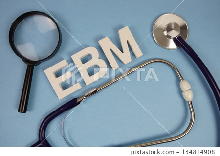 EBM abbreviation of Evidence Based Medicine alphabet letters with magnifying glass and stethoscope on blue background 134814908