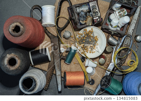 Thimbles in small wooden treasure chest, Spools of thread of various colour, Sewing needles stuck in a green miniature spools thread, Steel scissors and Measuring tape including pins in small round Thimbles in small wooden treasure chest, Spools of thread of various colour, Sewing needles stuck in a green miniature spools thread, Steel scissors and Measuring tape including pins in small round 134815083
