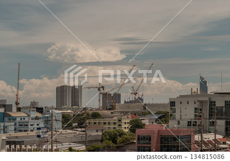 View of Construction of tall buildings with a crane and background of Dramatic sky in the city of Bangkok. View of Construction of tall buildings with a crane and background of Dramatic sky in the city of Bangkok. 134815086