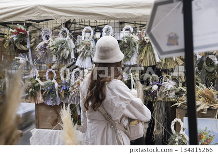 A woman shopping at a Christmas market A woman shopping at a Christmas market 134815266