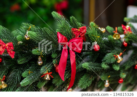 Christmas mantel decoration, Seasonal evergreen decoration featuring bows and tiny lights 134815326