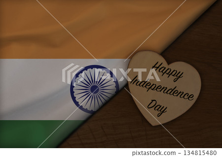 Indian flag on wooden surface with Happy Independence Day on wooden heart 134815480
