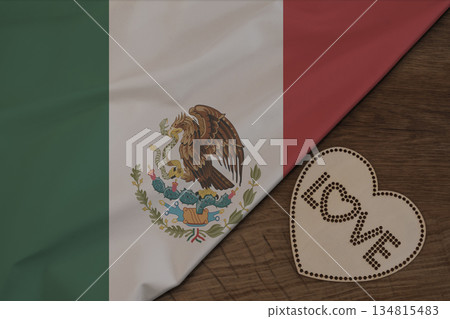 Mexican flag fabric on wooden surface and word LOVE on wooden heart patriotic postcard design Mexican flag fabric on wooden surface and word LOVE on wooden heart patriotic postcard design 134815483