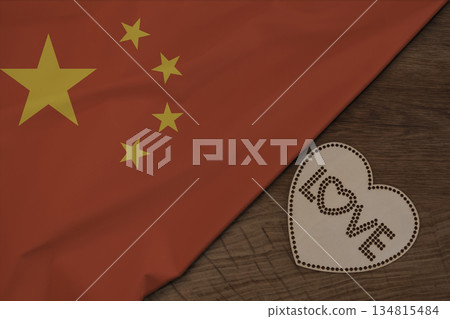 Chinese flag fabric on wooden surface and word LOVE on wooden heart patriotic postcard design 134815484