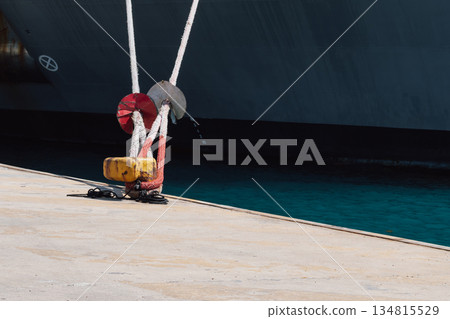 Mooring of a vessel in the port using mooring lines to a bollard on the quay 134815529