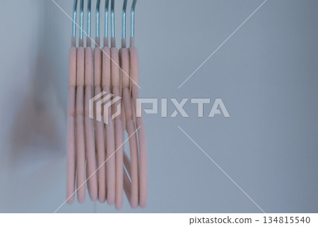 Children's pink velvet hangers with heart for girls clothes in empty wardrobe 134815540