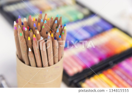 Colored pencils and oil pastels on a table Colored pencils and oil pastels on a table 134815555