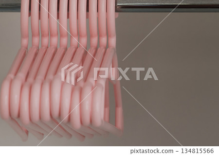 Plastic soft pink hangers for children's clothes in the wardrobe Plastic soft pink hangers for children's clothes in the wardrobe 134815566