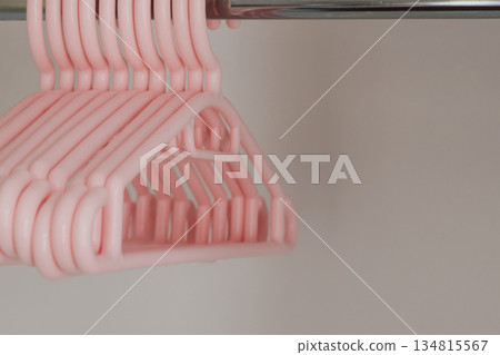 Plastic soft pink hangers for children's clothes in the wardrobe Plastic soft pink hangers for children's clothes in the wardrobe 134815567