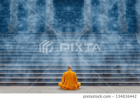 Peaceful meditation of a Buddhist monk in saffron robes at an ancient temple surrounded by incense smoke Peaceful meditation of a Buddhist monk in saffron robes at an ancient temple surrounded by incense smoke 134816442