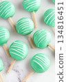 Glossy turquoise candy apples arranged on a marble surface create an enticing display perfect for celebrations or festive events 134816451