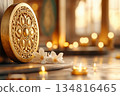 Intricate golden Dharma Wheel placed on an altar with incense, candles, and sacred texts for meditation and reflection 134816465