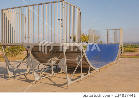Empty concrete skate park ramp for skateboarding and rollerblading action sports 134817441