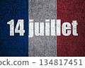 French flag on textured plaster wall with French text 14 juillet.  134817451