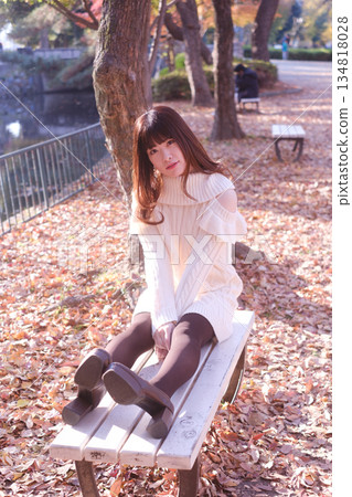 A woman sitting on a park bench A woman sitting on a park bench 134818028