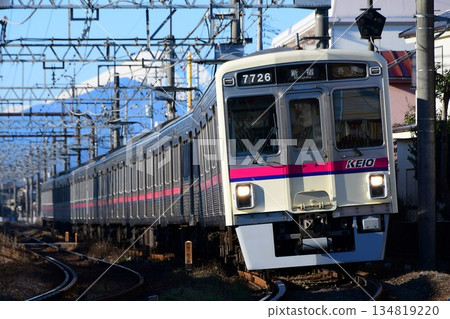 Keio 7000 series 7726F running with Mount Fuji in the background Keio 7000 series 7726F running with Mount Fuji in the background 134819220