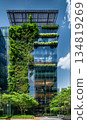 green plants and garden on modern glass skyscraper office building, nature and contemporary architecture, balance and harmony of environment and human, sustainability of ecosystem 134819269