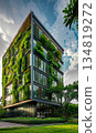 green plants and garden on modern glass skyscraper office building, nature and contemporary architecture, balance and harmony of environment and human, sustainability of ecosystem 134819272