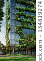 green plants and garden on modern glass skyscraper office building, nature and contemporary architecture, balance and harmony of environment and human, sustainability of ecosystem 134819274