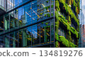 green plants and garden on modern glass skyscraper office building, nature and contemporary architecture, balance and harmony of environment and human, sustainability of ecosystem 134819276